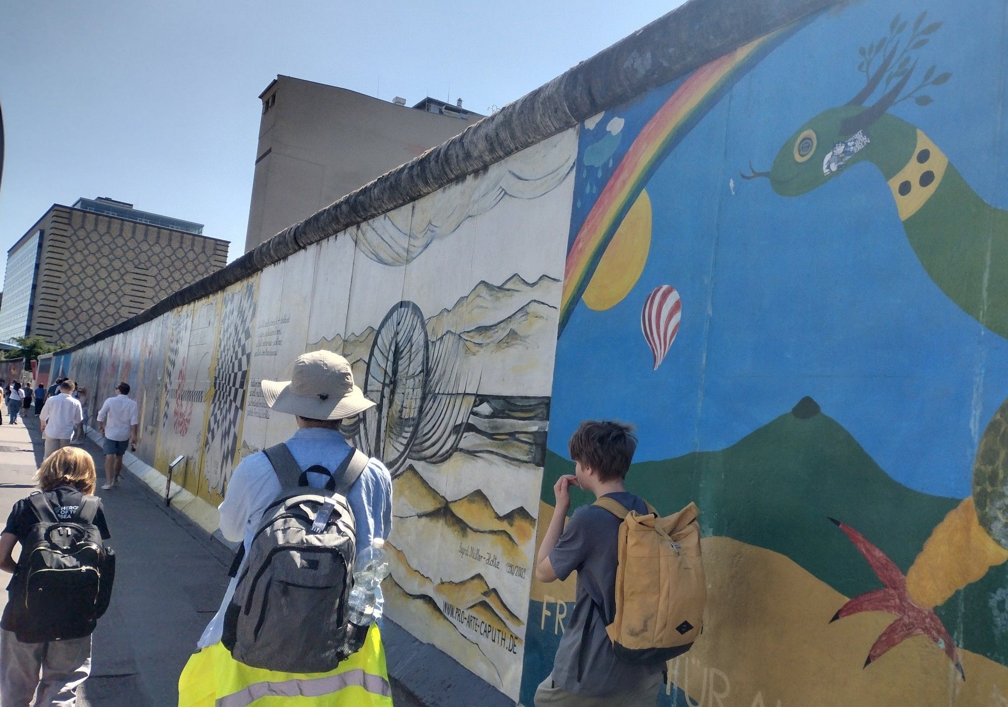 Group of Hack Club Horizons attendees walking past the East Side Gallery, Berlin.